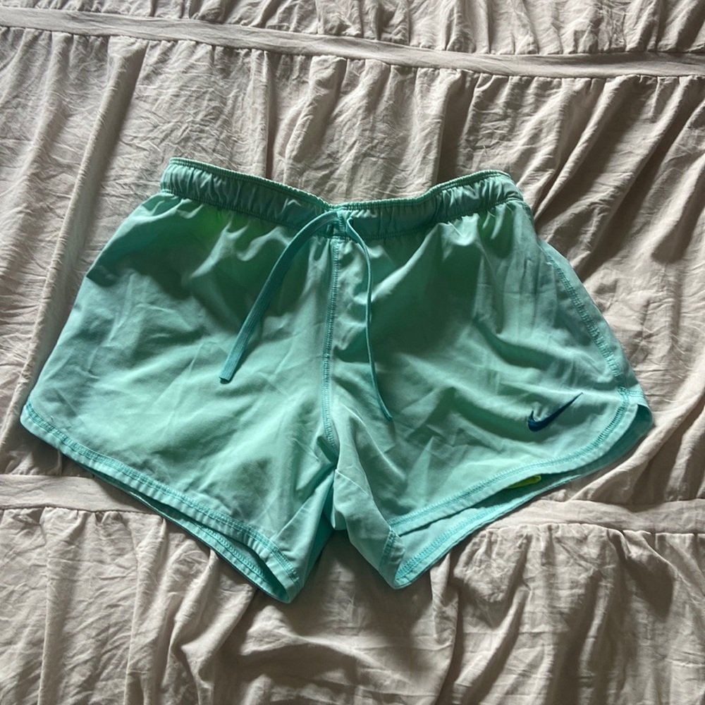 blue Nike shorts with built in yellow spandex underneath